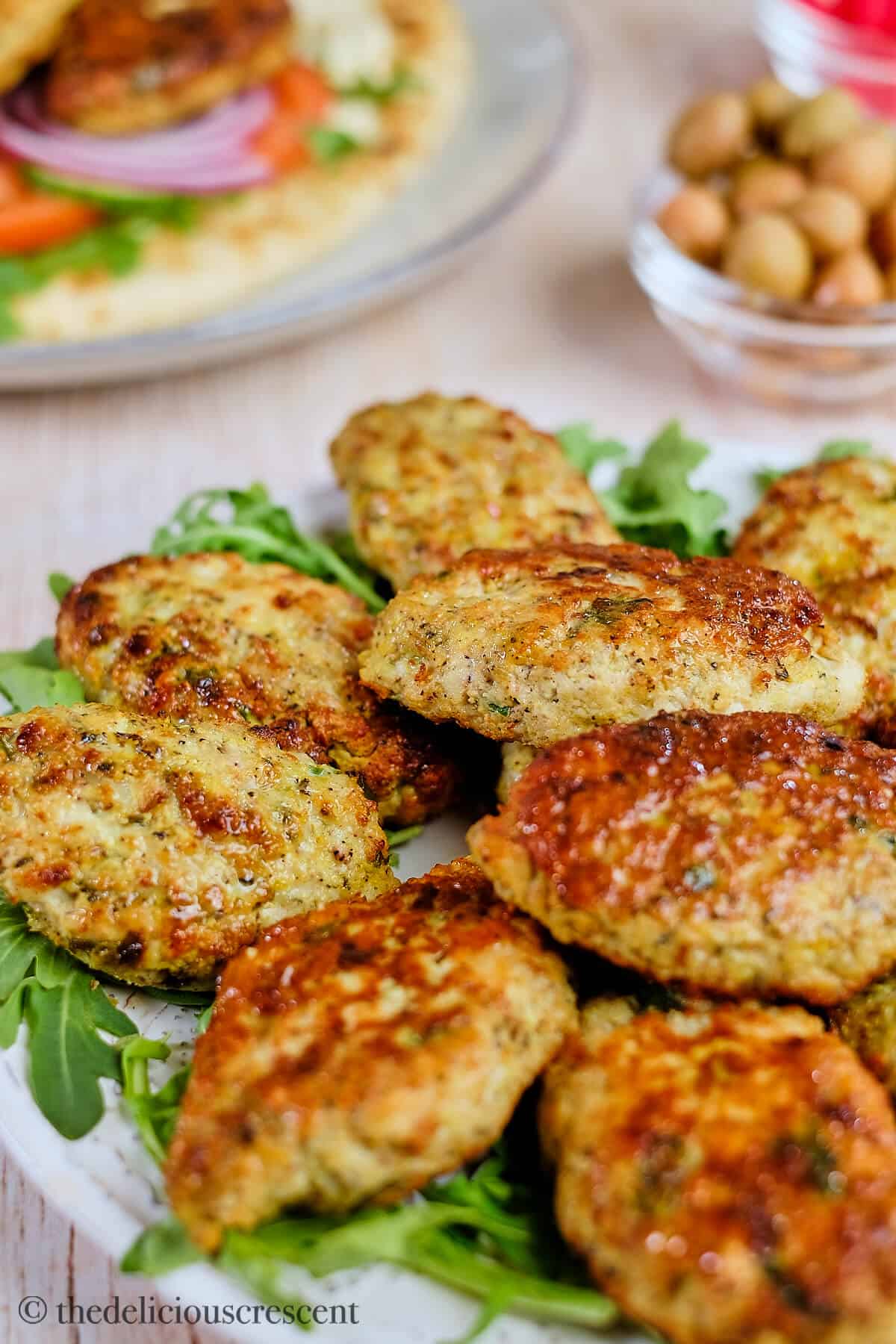 Several spicy meatballs arranged on a plate.