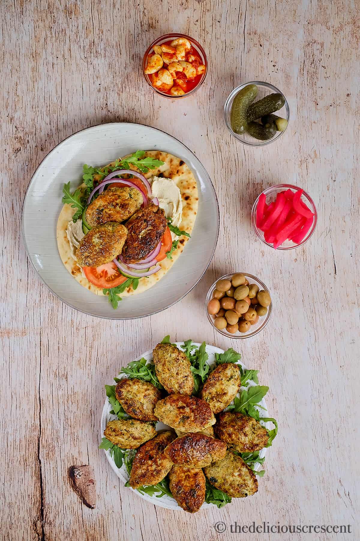 Chicken koftas served with bread, vegetables and pickles.