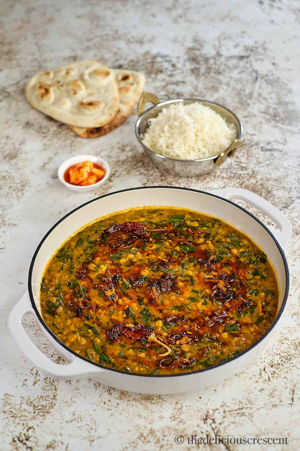 Dal palak served with rice and bread.