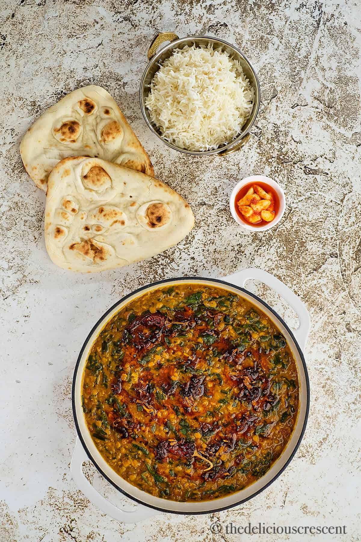 Overhead view of lentil and spinach curry with rice.