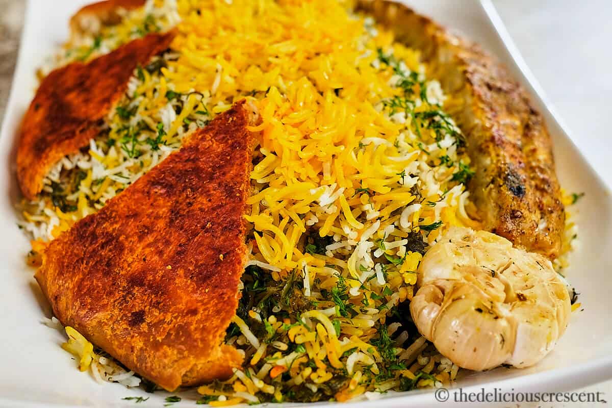 Sabzi polo, a Persian herb rice served in a white plate.