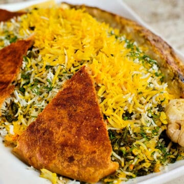 Close up view of Sabzi polo served on a table.