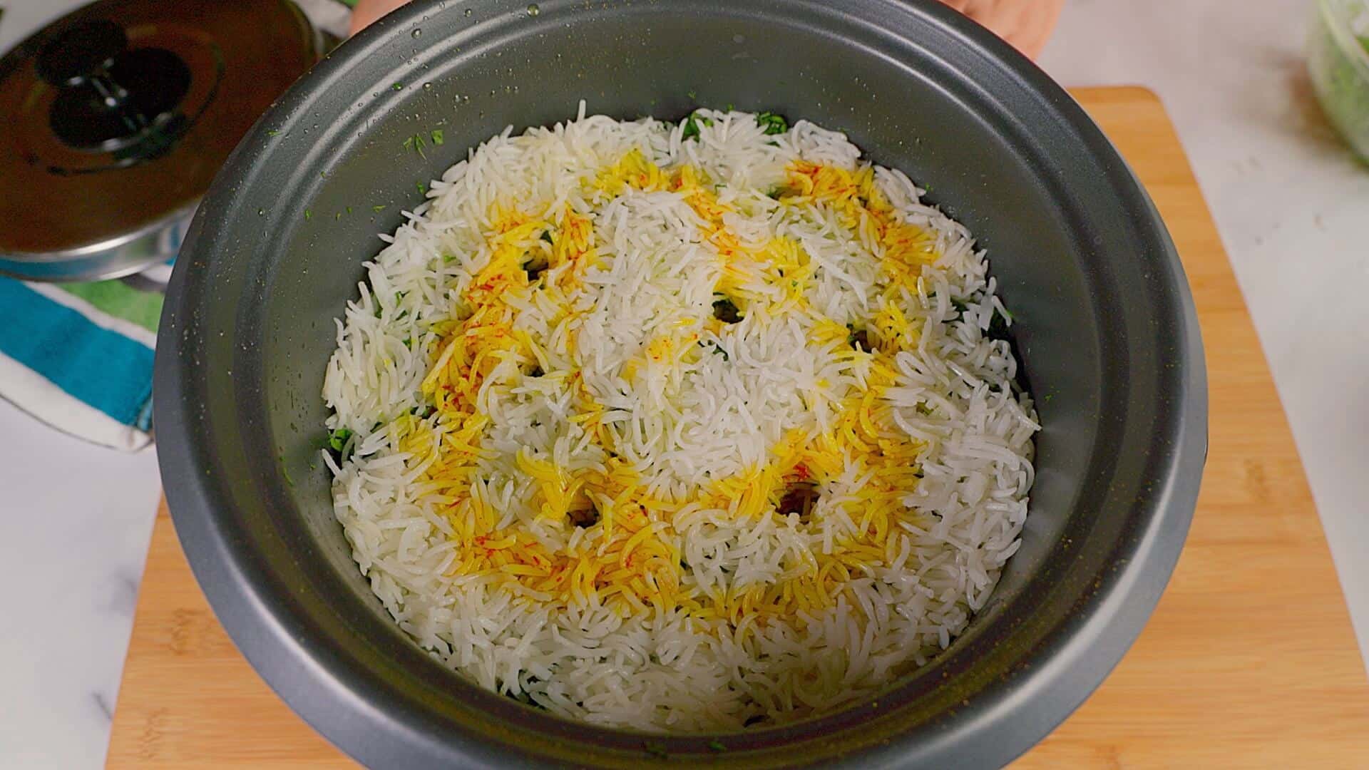 Final layer of rice followed by a sprinkle of saffron water.