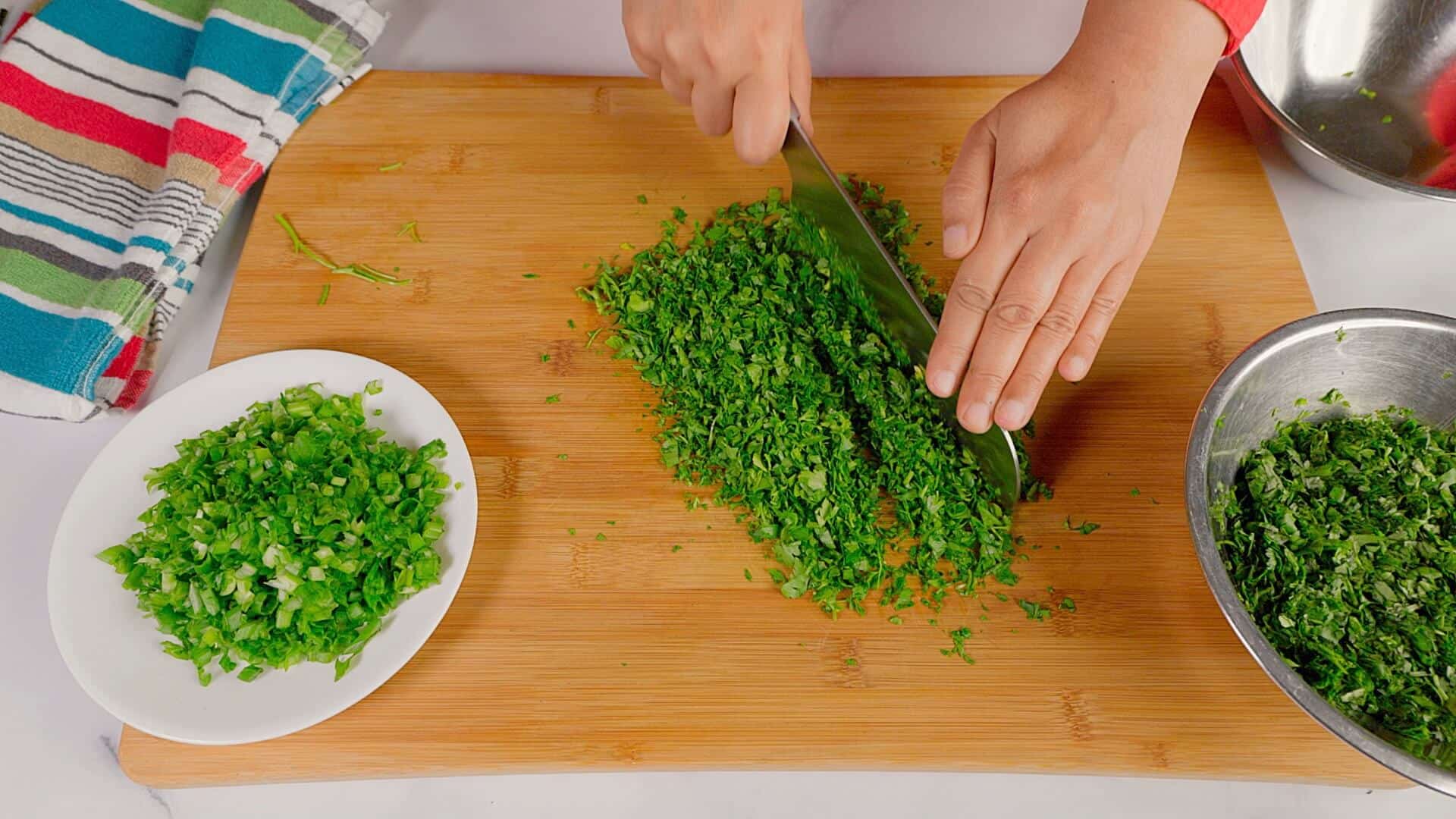 Herbs being chopped finely.