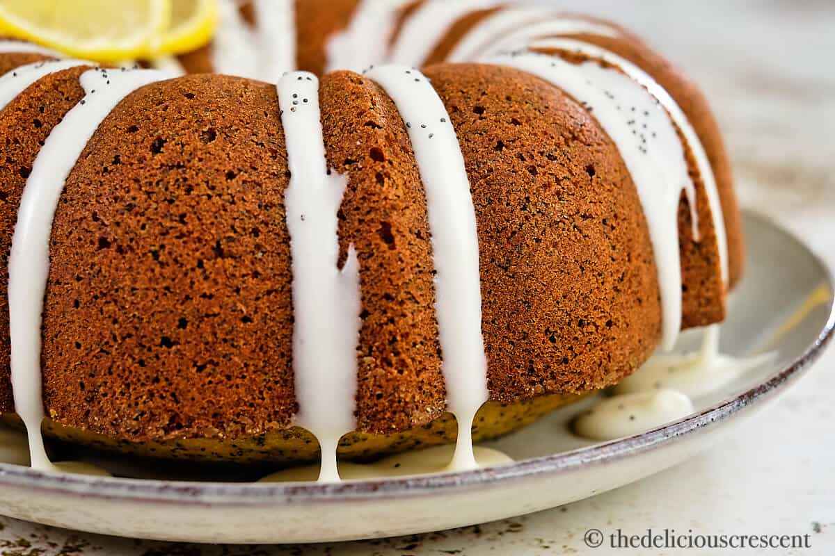 Lemon glaze dripping on the poppy seed cake.