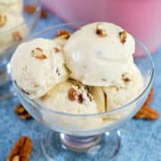 Close up view of maple pecan ice cream in a glass bowl.