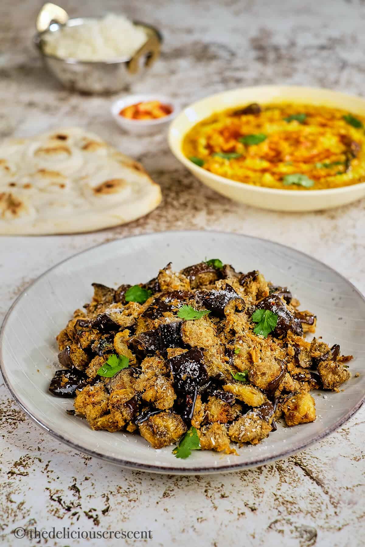 Oven roasted Indian style eggplant served with dal.