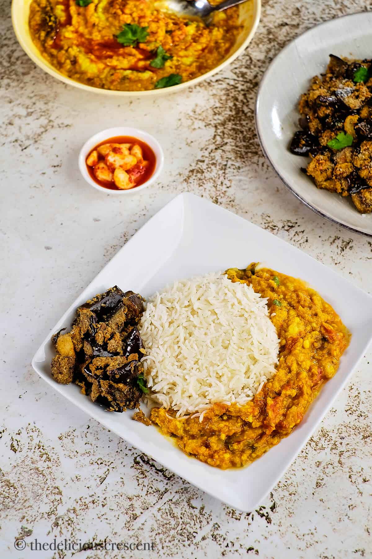 Spicy roasted eggplant served with rice and dal.