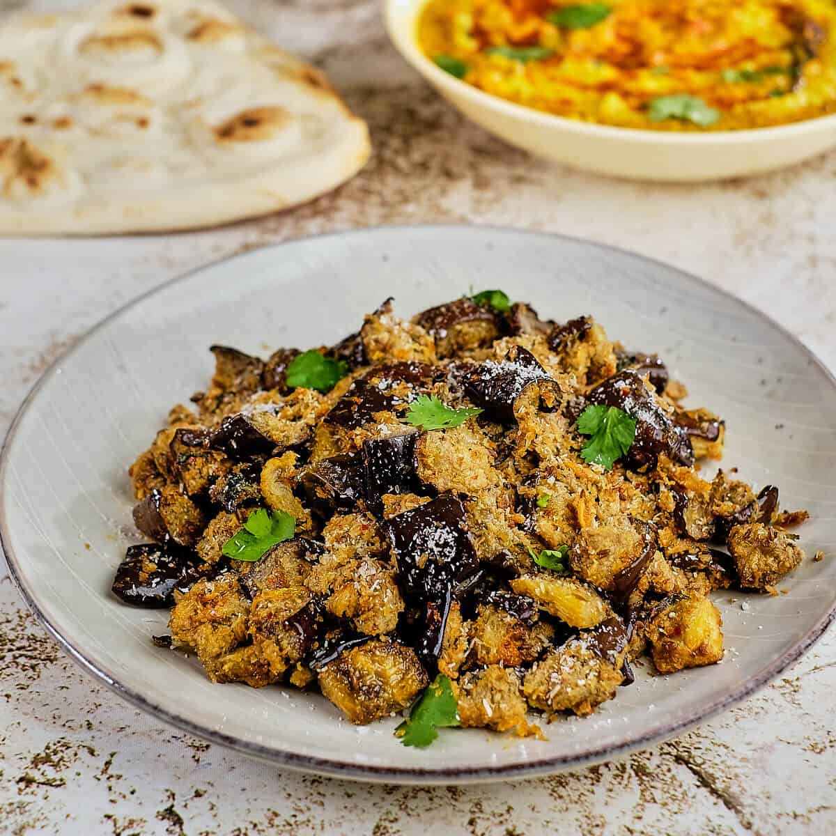 Close up view of oven roasted Indian style vegetable served with dal.