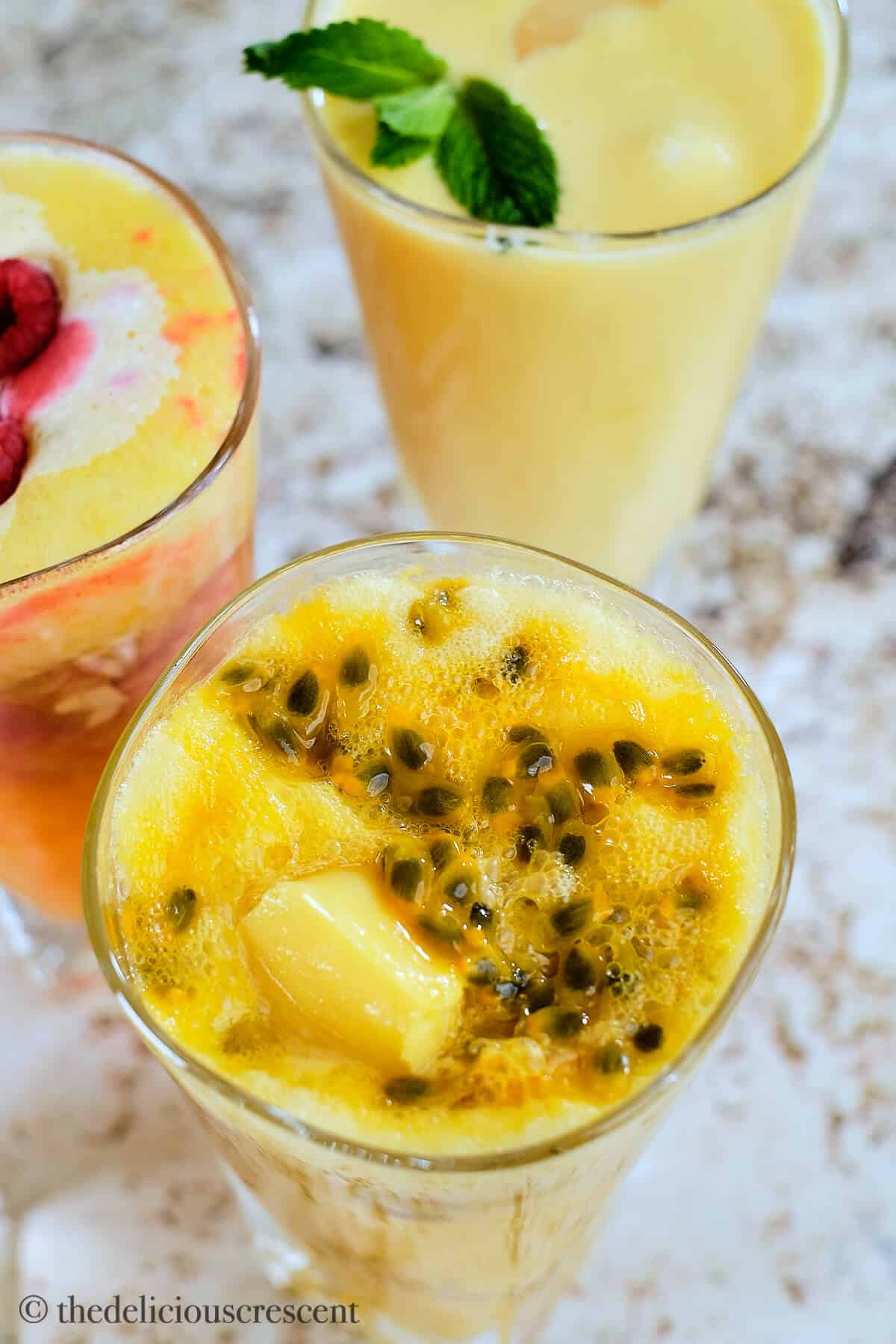 Peach passion fruit smoothie in a glass.