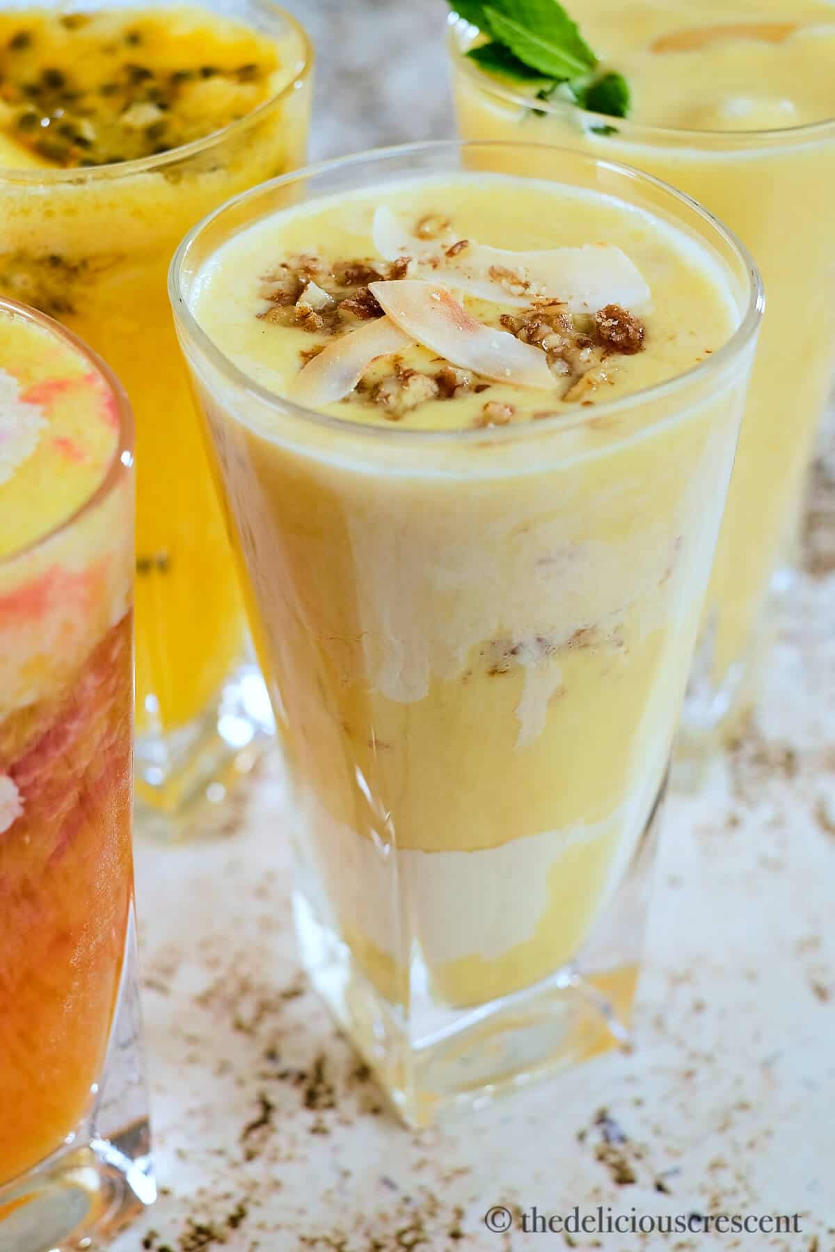 Peach smoothie topped with pecans and coconut.