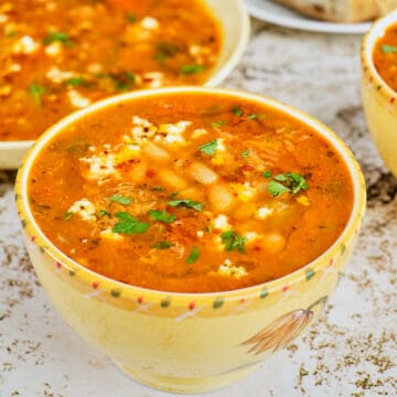 Close view of a bowl full of mediterranean white bean soup.