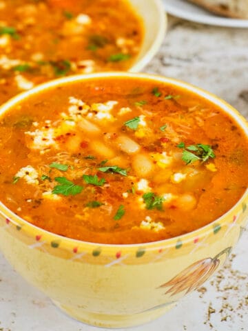 Close view of a bowl full of mediterranean white bean soup.