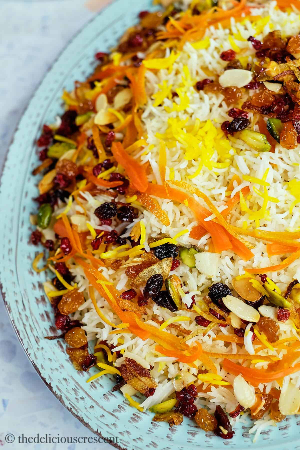 Persian jeweled rice served in a light blue plate.