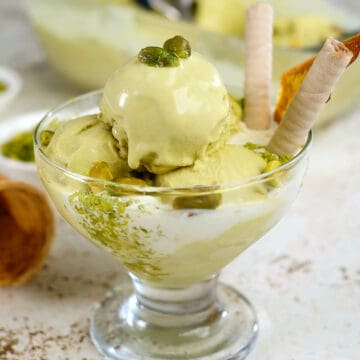 Close view of pistachio gelato served in a glass cup.