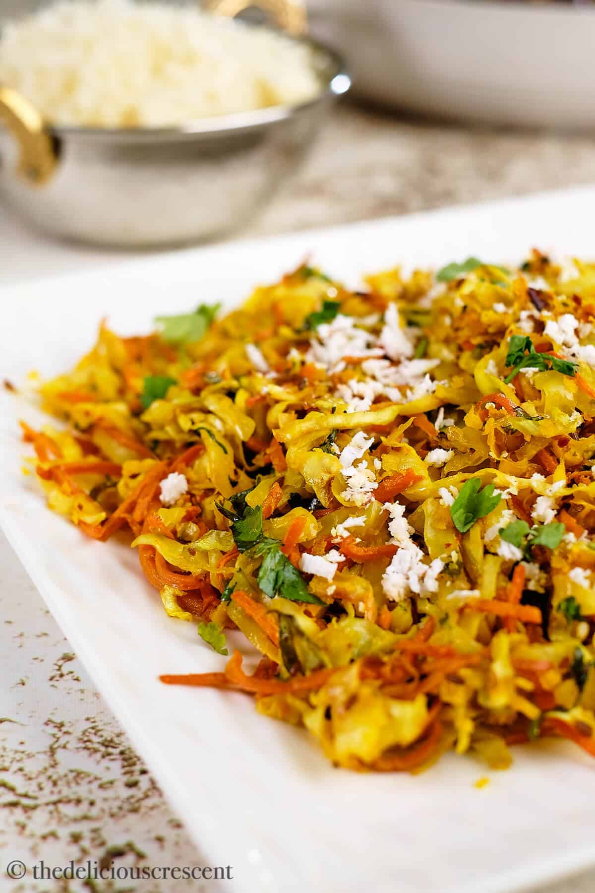 Indian shredded cabbage served in a white plate.