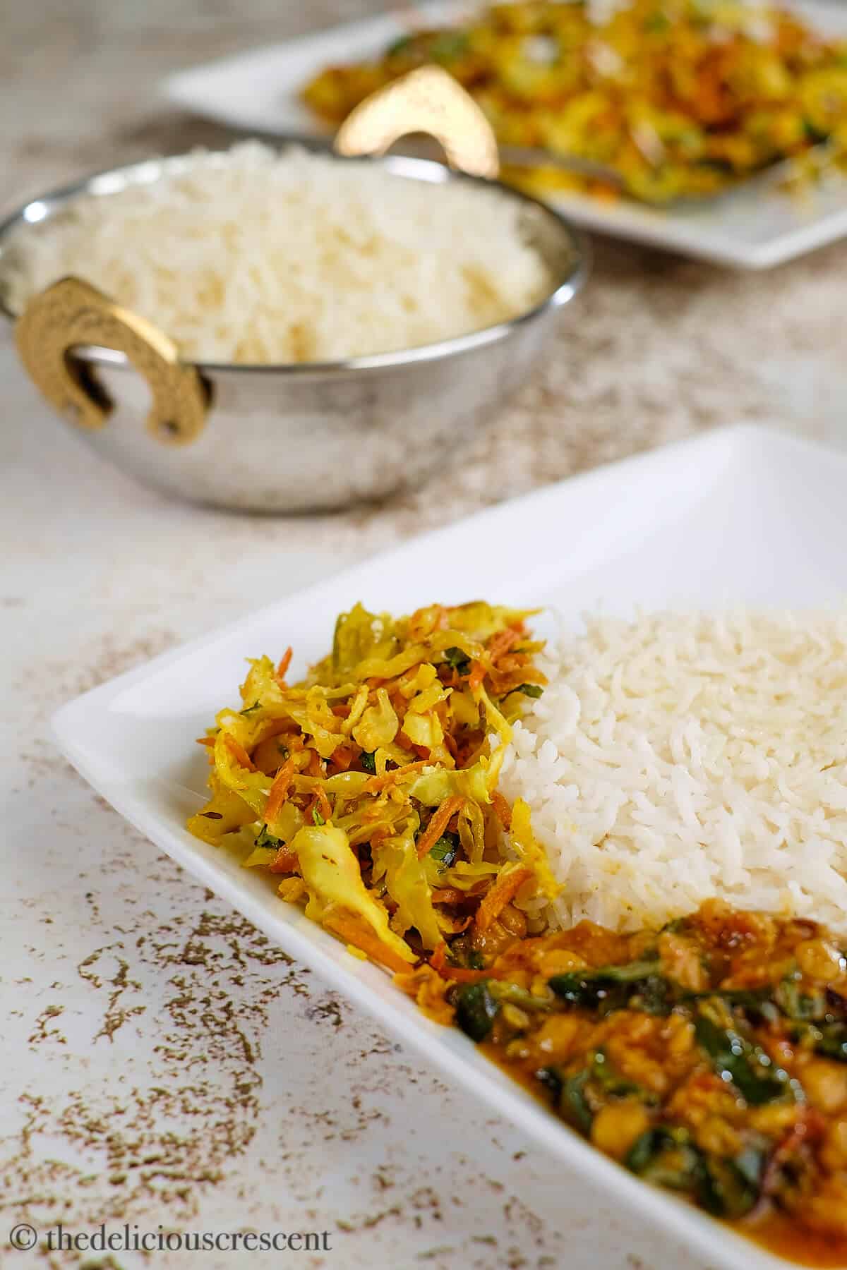 Oven roasted cabbage poriyal served with rice and dal.