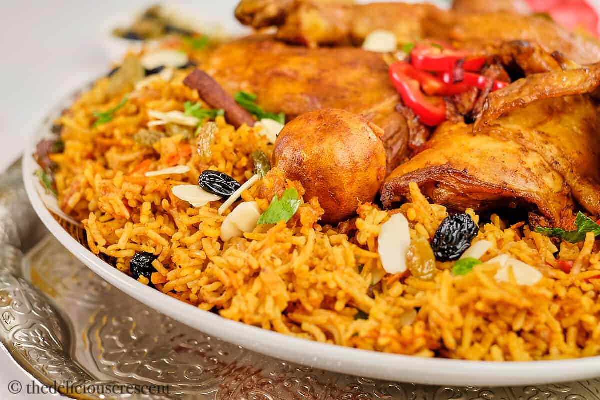 Saudi Arabian chicken kabsa in a round plate.