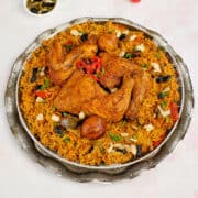 Close view of Saudi Arabian chicken and rice served on the table.