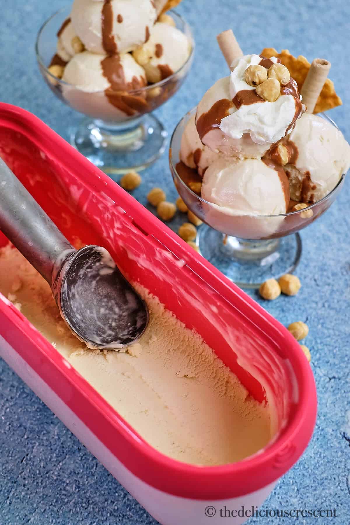 Two glass bowls full of Italian style ice cream with toppings.