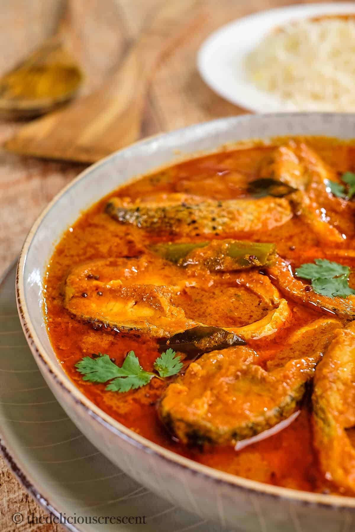 Fish cooked in a tomato-coconut sauce and served with rice.