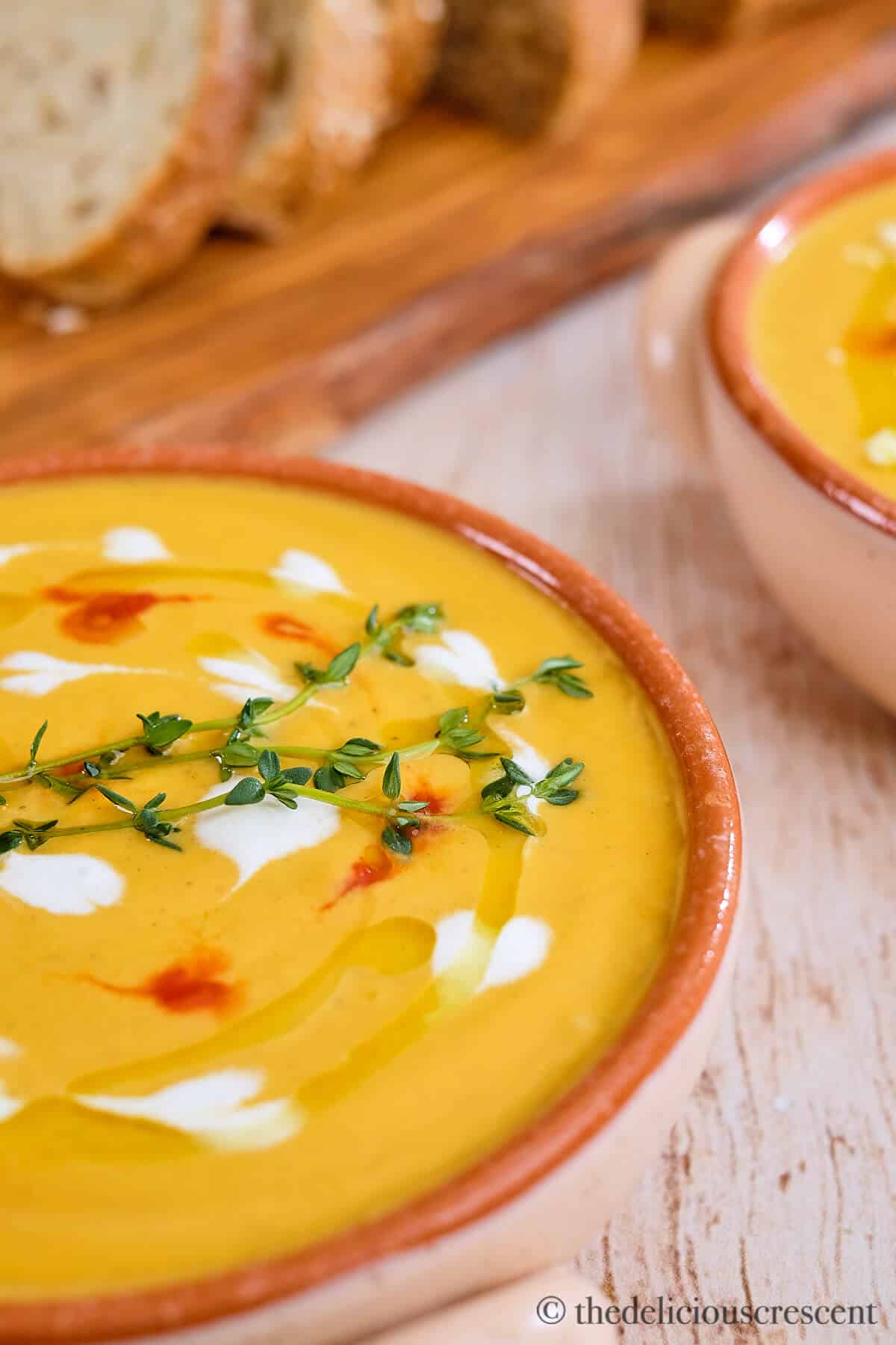 A bowl of spiced butternut squash soup on a table.