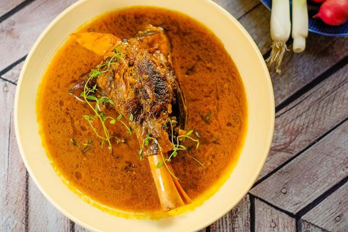 Overhead view of lamb shank with sauce.