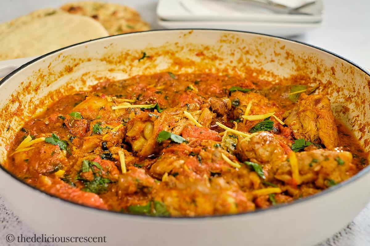 Front view of kadai chicken in a white dish.