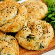 Close view of coiled borek (kol böreği) filled with spinach and feta.