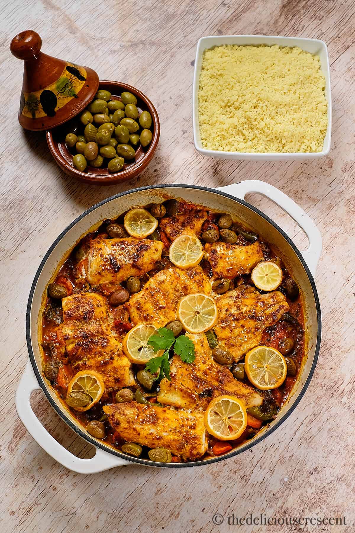 Moroccan tagine with white fish served on the table.