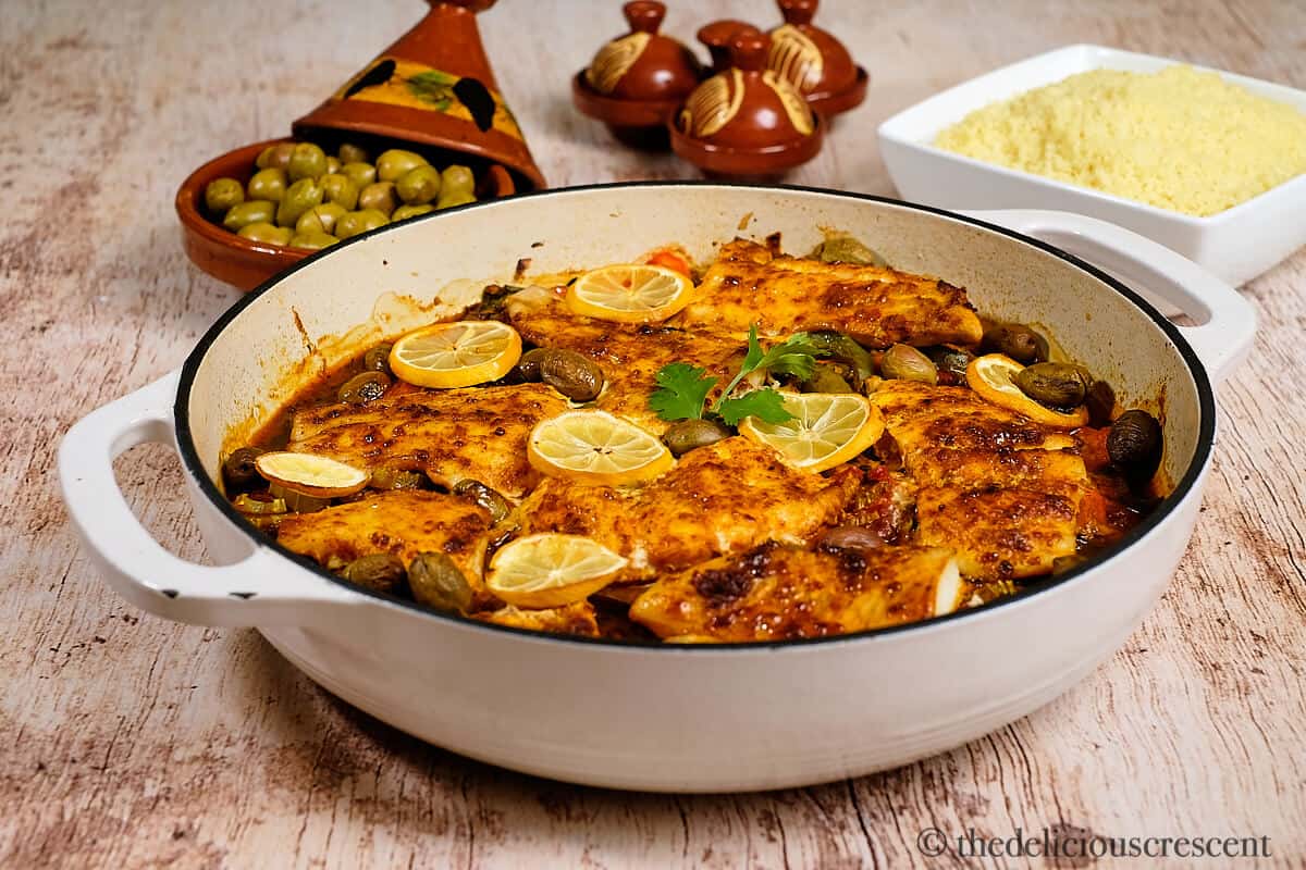 Fish tagine with couscous placed on the table.