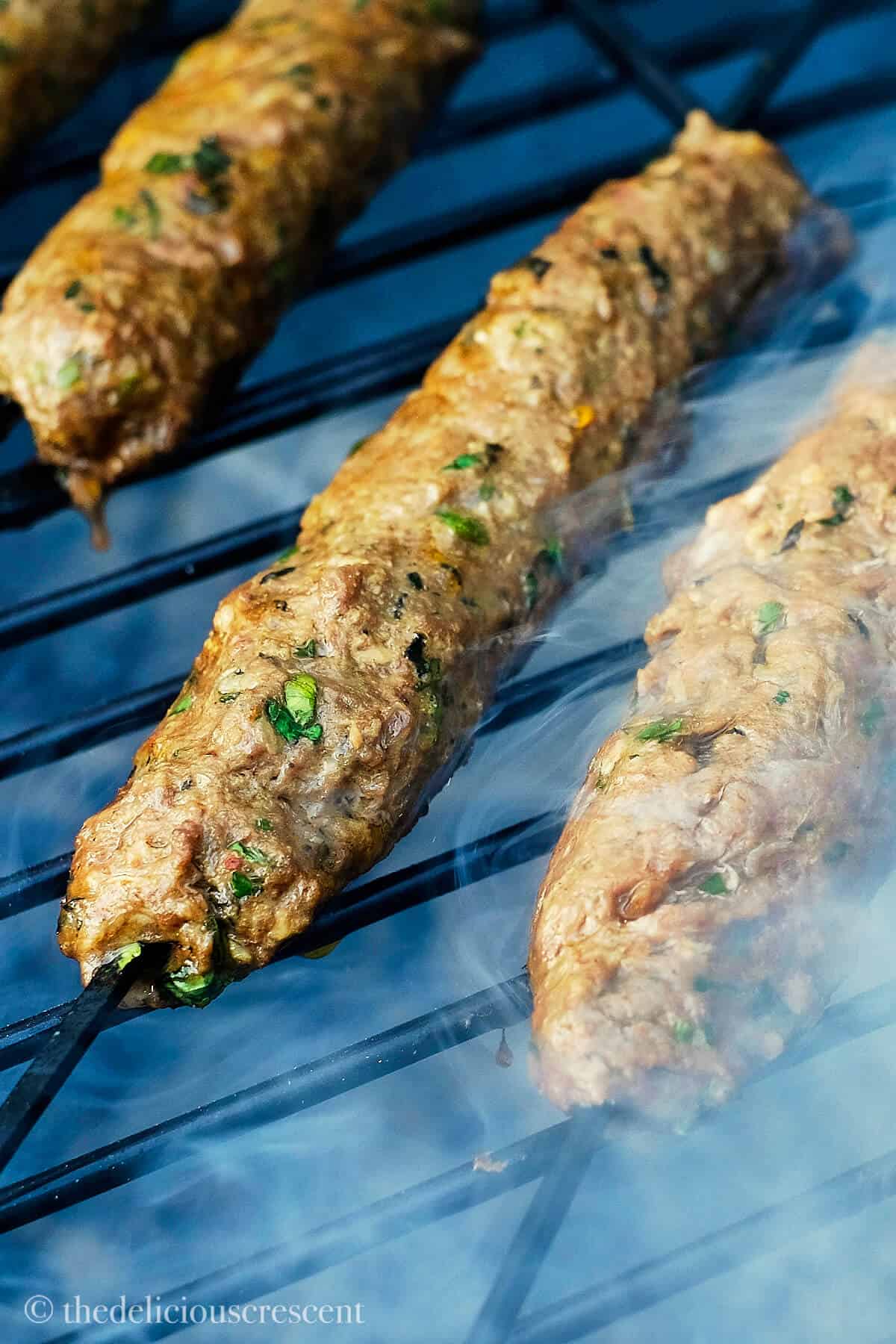 Grilling kefta bebabs on charcoal.